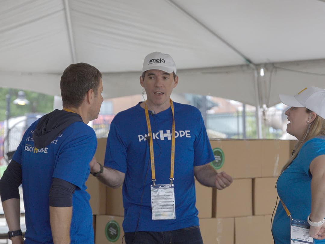 PackHope crew coordinating in front of staged kit boxes