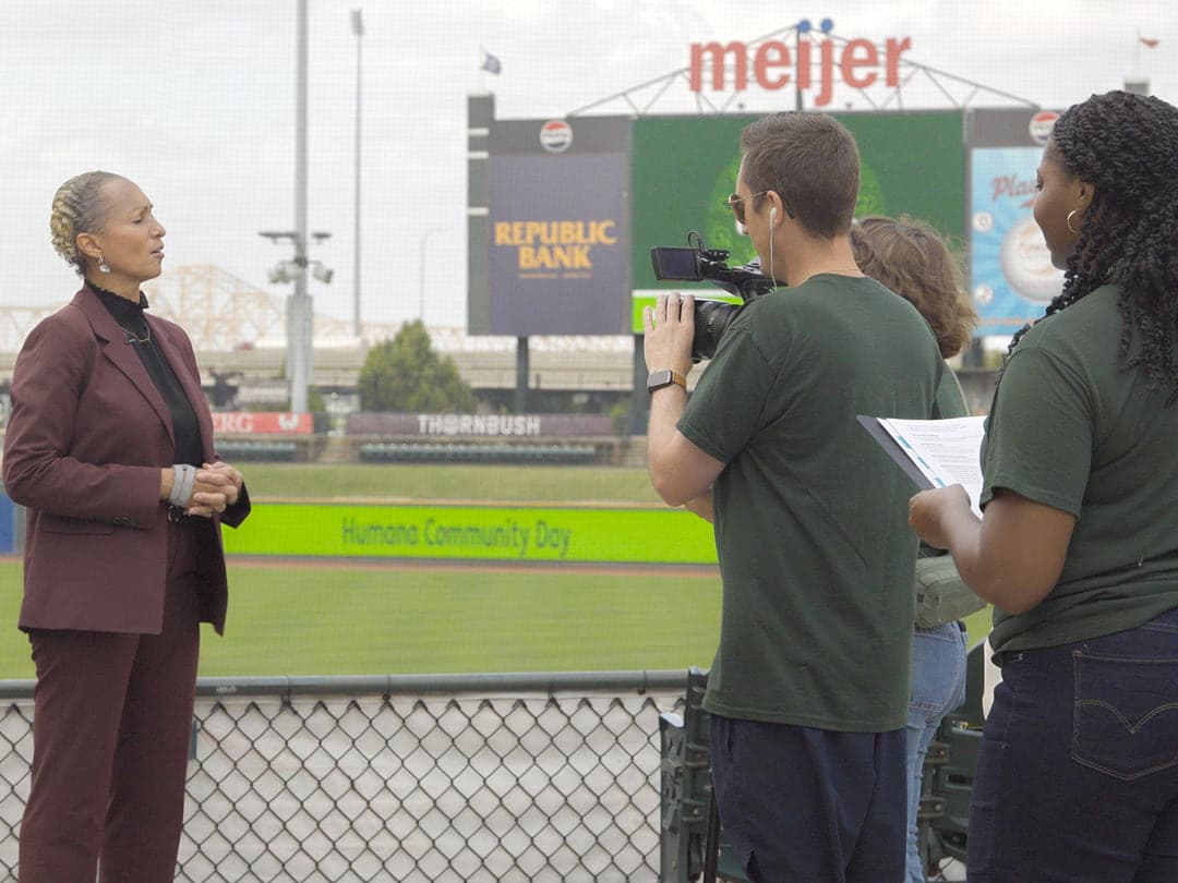 Humana executive being interviewed on camera at a Community Day site