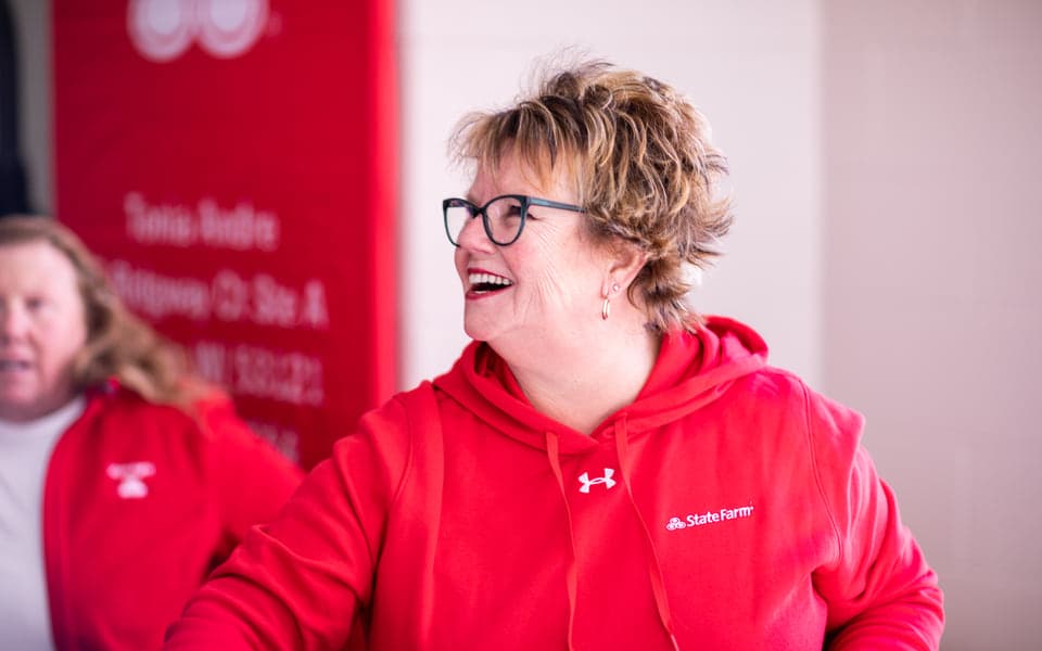 State Farm volunteer laughing during a build
