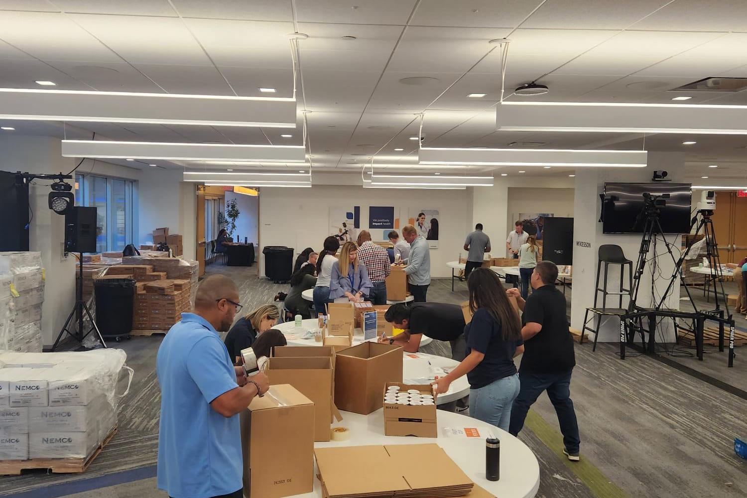 Wide view of a McKesson kit build spread across an open office floor