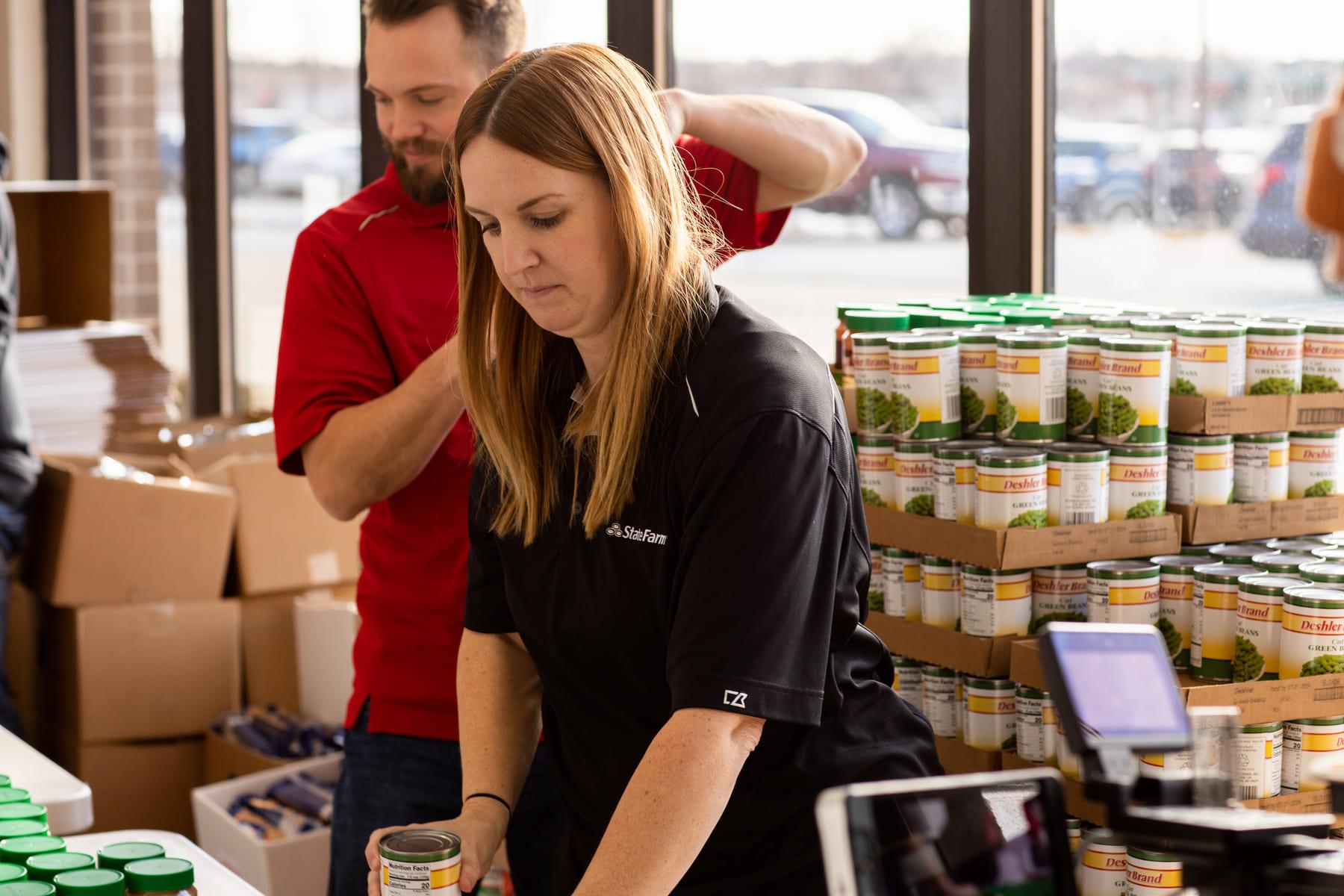 State Farm volunteer sorting canned green beans