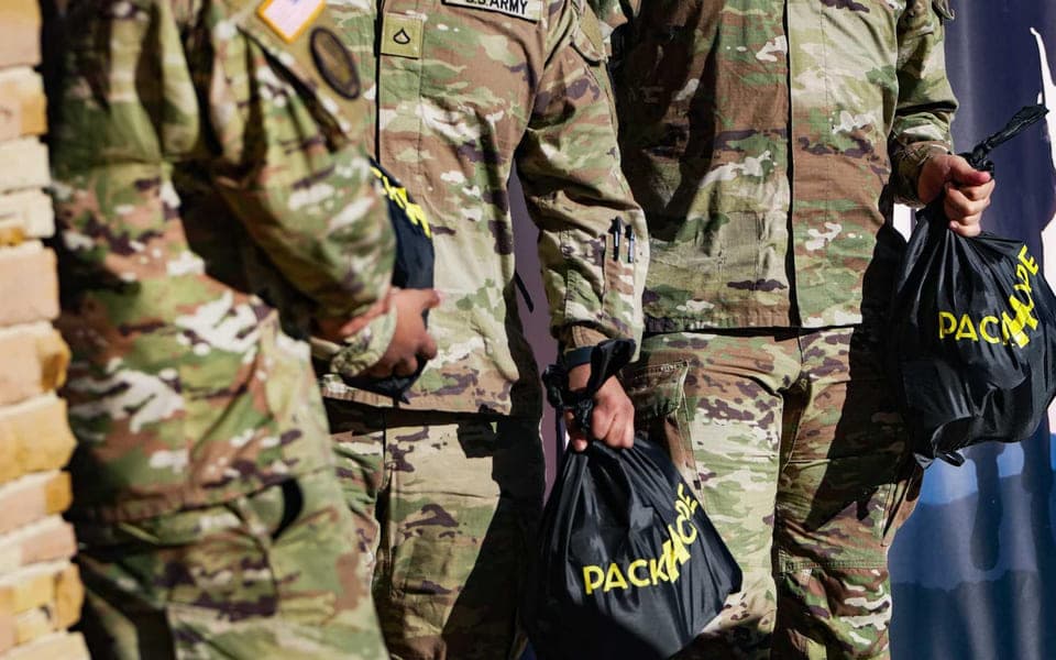 Soldiers carrying PackHope kit bags at Fort Cavazos